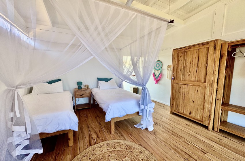 Bedroom with 2 single beds at Aloha 29 in Ponta Mamoli