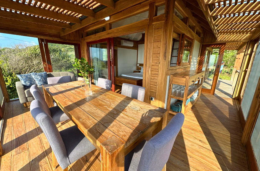 Dining table and hallway at Honey's House in Ponta Mamoli