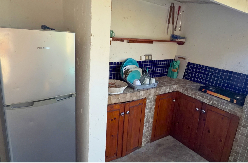 outdoor kitchen with fridge at Baleia azul beachfront tent 7 in Ponta Mamoli