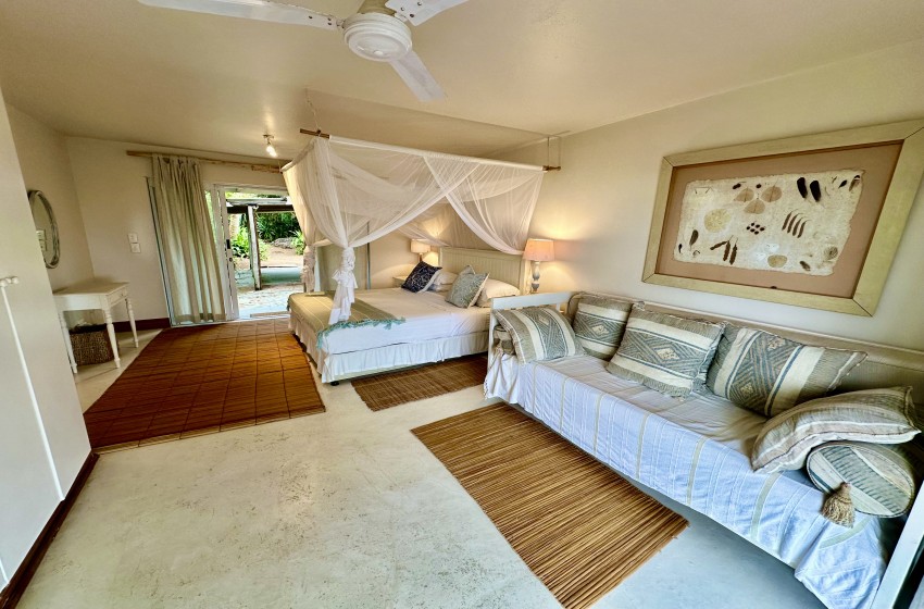 bedroom 1 with couch at kangela 11 in Ponta Malongane
